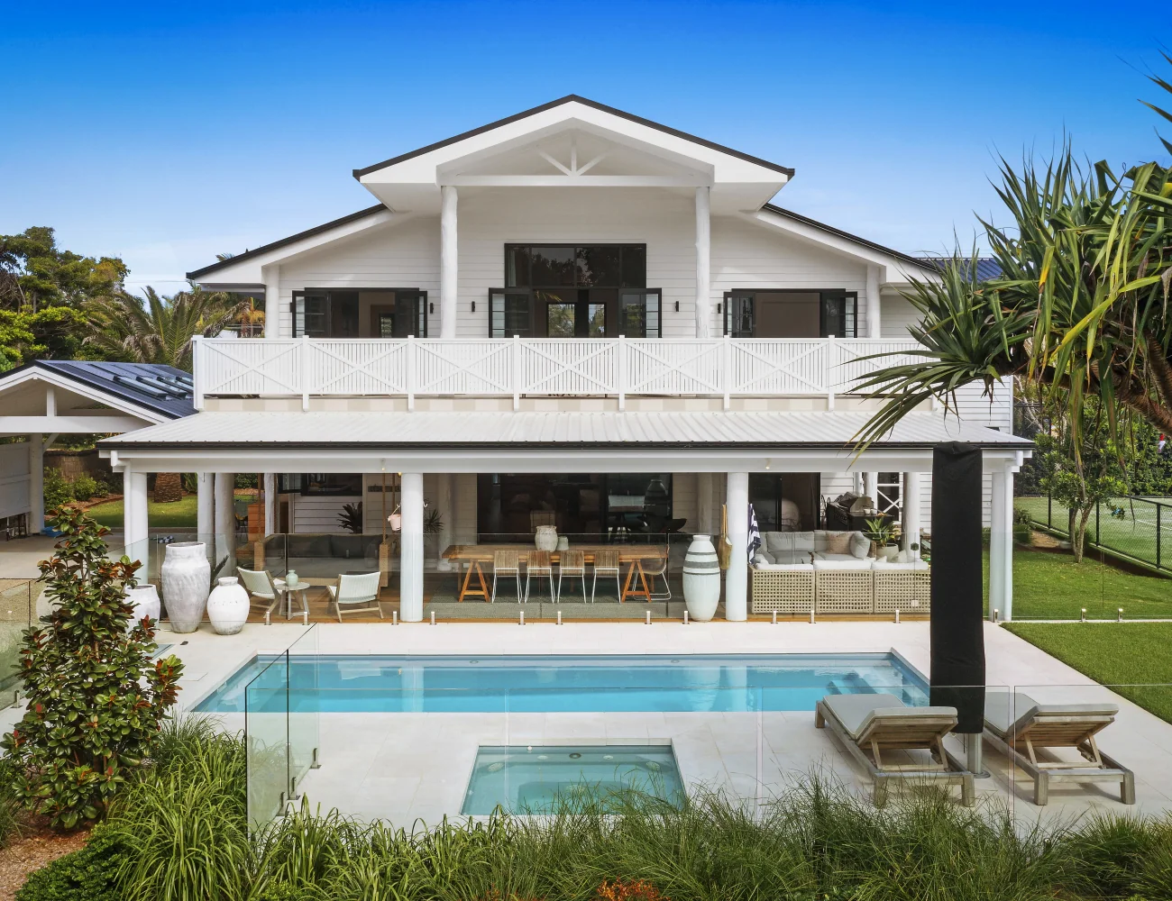 Avanti pool and spa beside a white coastal home