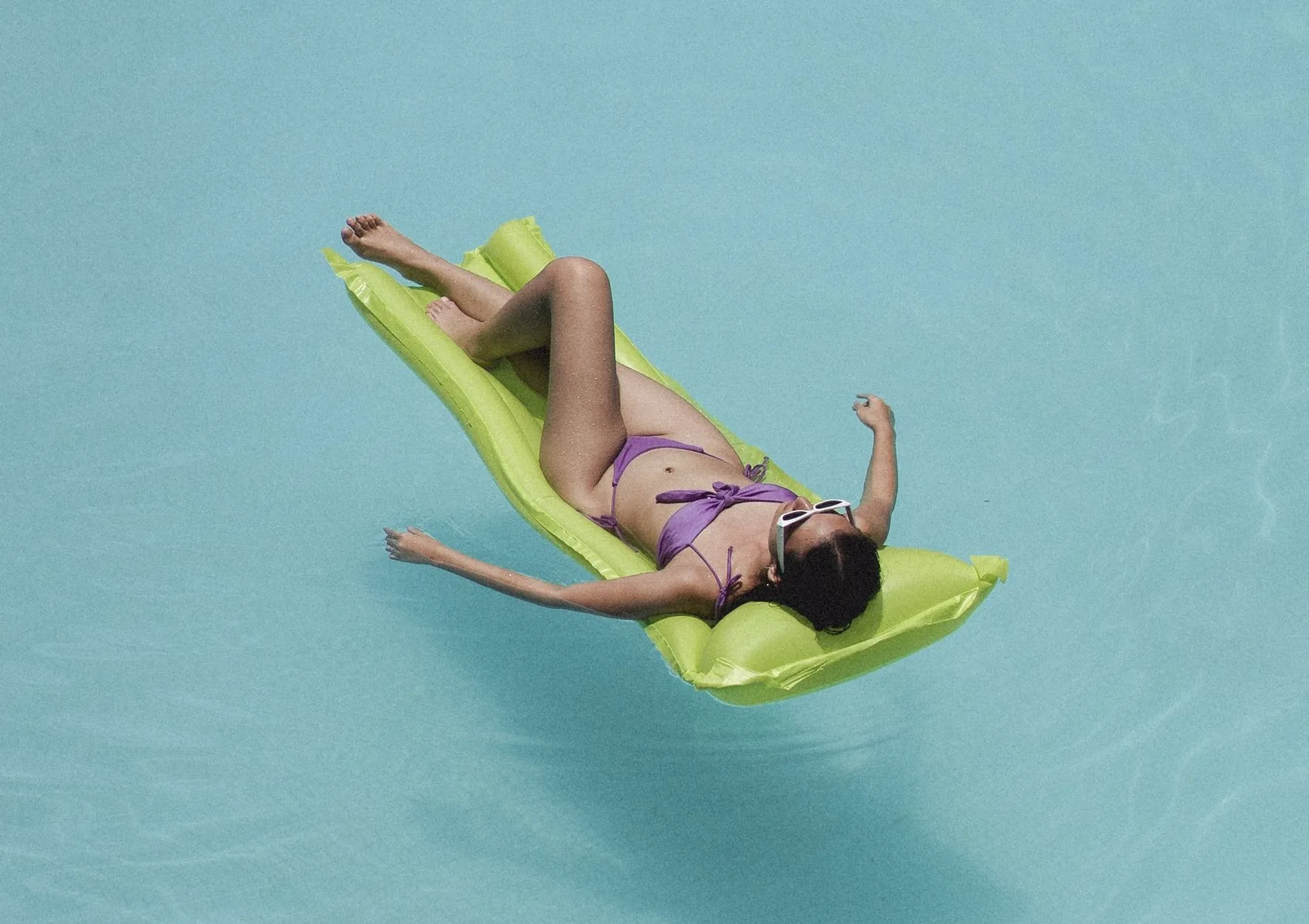 Woman relaxing in a large sized pool