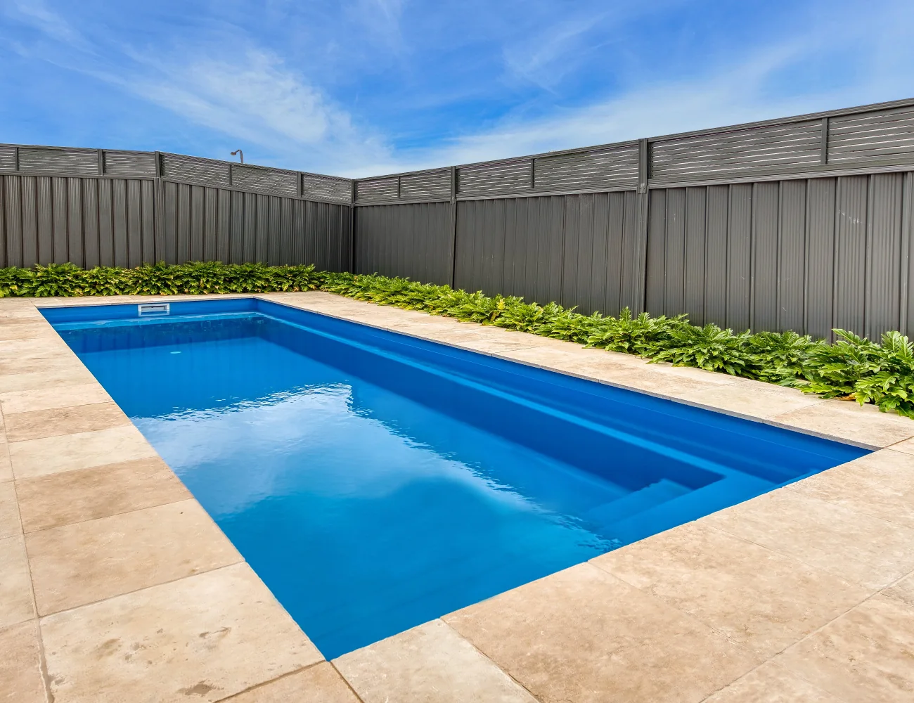 Davinci pool with blue water and stone paving