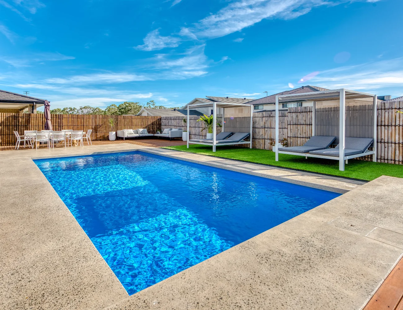 Entertainer pool beside lawn and outdoor cabanas