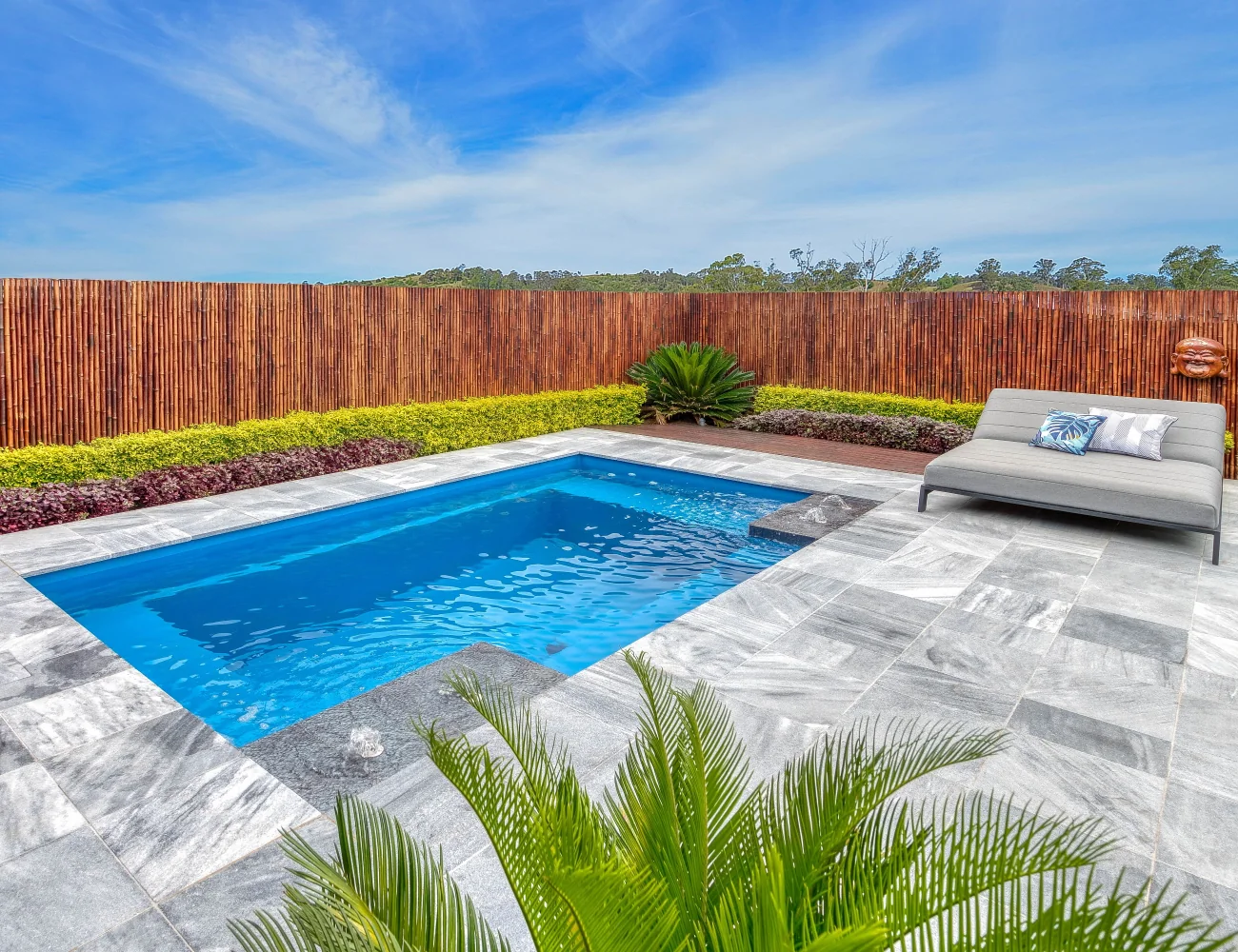 Nirvana pool with stone paving and garden beds