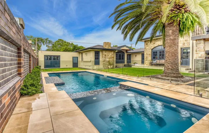 Serenity Masterbuilt pool with lounging areas in a landscaped backyard
