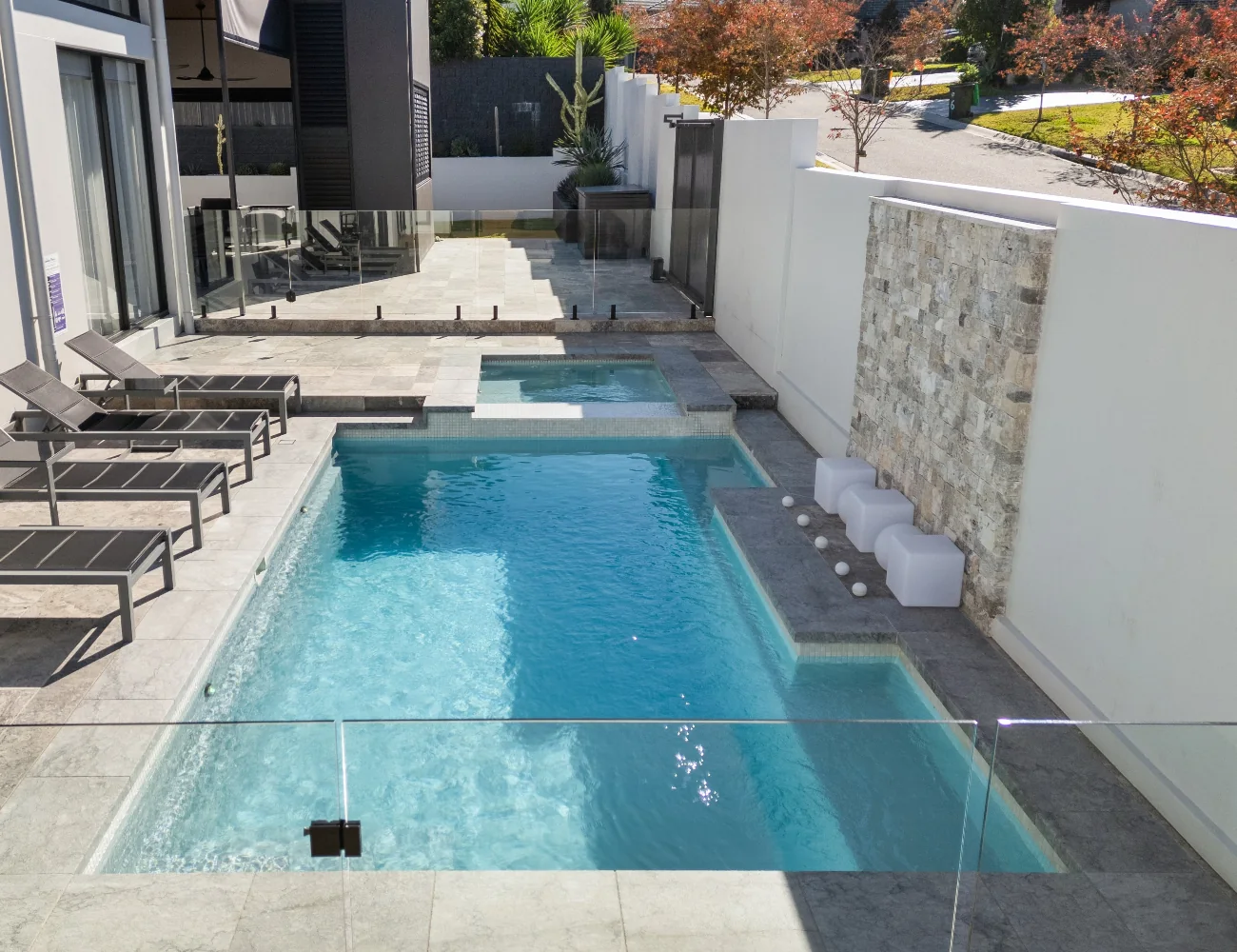 Serenity pool with a water feature in a landscaped courtyard